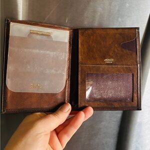 "AMITY COWHIDE" branding visible, this item is a vintage brown leather wallet